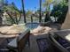 Outdoor patio view, with a hot tub, waterfront view, and patio seating at 10175 E Cochise Dr, Scottsdale, AZ 85258