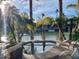 Backyard patio featuring a private hot tub, scenic waterfront views, and lounge chairs at 10175 E Cochise Dr, Scottsdale, AZ 85258
