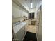 Bright laundry room with modern washer, dryer, lots of cabinets, and a built-in sink at 10175 E Cochise Dr, Scottsdale, AZ 85258