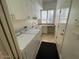 Practical laundry room with modern appliances, ample cabinet space, and natural light at 10175 E Cochise Dr, Scottsdale, AZ 85258