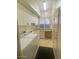 Well-lit laundry room with a sink, cabinets, and modern appliances at 10175 E Cochise Dr, Scottsdale, AZ 85258