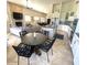 Open floor plan with kitchen, breakfast nook, living area with fireplace, and dining room at 10175 E Cochise Dr, Scottsdale, AZ 85258