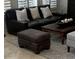 The living room has leather furniture, tile floors and white shutters at 10175 E Cochise Dr, Scottsdale, AZ 85258
