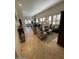Open-concept living area with tile floors, plantation shutters and comfortable furniture at 10175 E Cochise Dr, Scottsdale, AZ 85258
