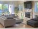 Living room with a fireplace, backyard view, and tile flooring at 10175 E Cochise Dr, Scottsdale, AZ 85258