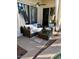 Comfortable seating area with neutral colored outdoor furniture, ceiling fan and palm tree rug at 10175 E Cochise Dr, Scottsdale, AZ 85258