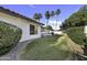 Side yard with landscaped grass, and a view of the covered patio at 1441 W Sea Haze Dr, Gilbert, AZ 85233