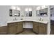 Double vanity featuring a makeup area and modern lighting, complemented by sleek countertops and cabinetry at 1441 W Sea Haze Dr, Gilbert, AZ 85233