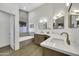 Bathroom featuring double vanity, a soaking tub, and modern finishes at 1441 W Sea Haze Dr, Gilbert, AZ 85233