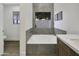 Soaking tub offers relaxation with serene outdoor view, stylishly integrated into a modern bathroom design at 1441 W Sea Haze Dr, Gilbert, AZ 85233