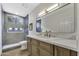 Modern bathroom featuring tiled walk-in shower, floating vanity with white marble countertops and gold fixtures at 1441 W Sea Haze Dr, Gilbert, AZ 85233