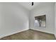 Empty bedroom with vinyl floors, neutral walls, bright natural light, and a window view at 1441 W Sea Haze Dr, Gilbert, AZ 85233