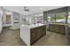 Open-concept kitchen with stainless appliances, large island, and adjacent living area at 1441 W Sea Haze Dr, Gilbert, AZ 85233