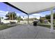 Covered patio area with table, chairs, barbecue, and a view of the backyard pool at 1441 W Sea Haze Dr, Gilbert, AZ 85233
