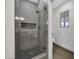 Walk-in shower features modern gray tile, built-in niche, and sleek glass enclosure at 1441 W Sea Haze Dr, Gilbert, AZ 85233