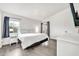 Bright bedroom with a plush bed, hardwood floors, French doors and great natural light at 14801 N 25Th Dr # 2, Phoenix, AZ 85023