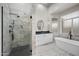 Bright, spa-like bathroom with glass shower, soaking tub, and modern finishes at 15064 N 54Th Way, Scottsdale, AZ 85254