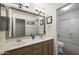 Bathroom with dual sinks, large framed mirror and walk in shower at 15064 N 54Th Way, Scottsdale, AZ 85254