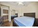 Bright bedroom features wood floors, ceiling fan, and mirrored closet doors at 15064 N 54Th Way, Scottsdale, AZ 85254