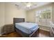 Cozy bedroom with ceiling fan, wood floors, and natural light from shuttered windows at 15064 N 54Th Way, Scottsdale, AZ 85254