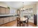 Kitchen eat-in area features plantation shutters and a charming chandelier at 15064 N 54Th Way, Scottsdale, AZ 85254