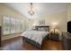 Spacious main bedroom with plantation shutters and a stylish chandelier at 15064 N 54Th Way, Scottsdale, AZ 85254