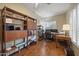 Cozy office space featuring warm wood floors, custom shelves, and bright window shutters at 15064 N 54Th Way, Scottsdale, AZ 85254