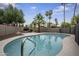 Refreshing pool features a handrail entry and is surrounded by lush desert landscaping at 15064 N 54Th Way, Scottsdale, AZ 85254