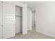 Bedroom with doors and sliding closet, with neutral carpet and white walls at 17854 W Mission Ln, Waddell, AZ 85355