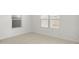 Bright bedroom featuring tile flooring and large windows with natural light at 17854 W Mission Ln, Waddell, AZ 85355