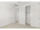 Bedroom with doors and sliding closet, with neutral carpet and white walls at 17854 W Mission Ln, Waddell, AZ 85355