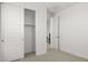 Bedroom with open closet, door, with neutral carpet and white walls at 17854 W Mission Ln, Waddell, AZ 85355