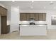 Bright kitchen showcasing a center island with quartz countertop, stainless steel appliances, and modern cabinetry at 17854 W Mission Ln, Waddell, AZ 85355