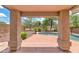 Covered patio with a view of a sparkling pool and lush landscaping in the private backyard at 1821 E Patrick Ln, Phoenix, AZ 85024