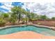 Private backyard with a sparkling pool, waterfall feature, and desert landscaping, enclosed by a fence at 1821 E Patrick Ln, Phoenix, AZ 85024