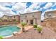 Spacious backyard featuring a pool, patio, desert landscaping, and two-story house at 1821 E Patrick Ln, Phoenix, AZ 85024