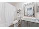 Practical bathroom featuring a single sink vanity, toilet, and shower with a curtain for everyday convenience at 1821 E Patrick Ln, Phoenix, AZ 85024