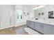 Bright bathroom with a glass shower, tub, and dual sinks at 1821 E Patrick Ln, Phoenix, AZ 85024