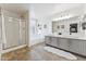 Well-lit bathroom features a glass shower, separate tub, double sinks with vanity, and tiled flooring at 1821 E Patrick Ln, Phoenix, AZ 85024