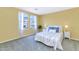 Inviting bedroom with sunny yellow walls, vibrant bedding, and large windows with mountain views at 1821 E Patrick Ln, Phoenix, AZ 85024