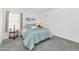 Cozy bedroom features soft blue bedding, neutral walls, and window with natural light at 1821 E Patrick Ln, Phoenix, AZ 85024