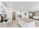 Bright kitchen features white cabinets, a center island, and modern appliances, with a tiled floor at 1821 E Patrick Ln, Phoenix, AZ 85024