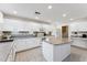 Spacious kitchen featuring white cabinets, a center island, and modern appliances, with a tiled floor at 1821 E Patrick Ln, Phoenix, AZ 85024