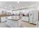 Bright kitchen with white cabinetry, a center island, and neutral countertops is ready for its new owners at 1821 E Patrick Ln, Phoenix, AZ 85024