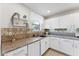Bright kitchen featuring white cabinets, modern appliances, and a tiled backsplash and flooring at 1821 E Patrick Ln, Phoenix, AZ 85024