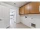 Laundry room with tiled flooring and built-in storage solutions, conveniently located near the kitchen at 1821 E Patrick Ln, Phoenix, AZ 85024