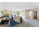 Comfortable living room with plush carpeting and a view into the neighboring bedroom at 1821 E Patrick Ln, Phoenix, AZ 85024