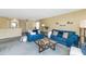 Open-concept living room with blue sofas, a glass-top coffee table, and stylish decor at 1821 E Patrick Ln, Phoenix, AZ 85024