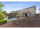 Backyard featuring a beautiful swimming pool, rock waterfall, and well-maintained landscaping, perfect for outdoor living at 1821 E Patrick Ln, Phoenix, AZ 85024