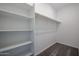A spacious walk-in closet featuring built-in shelving and ample hanging space for organization at 19320 N Diego Way, Maricopa, AZ 85138